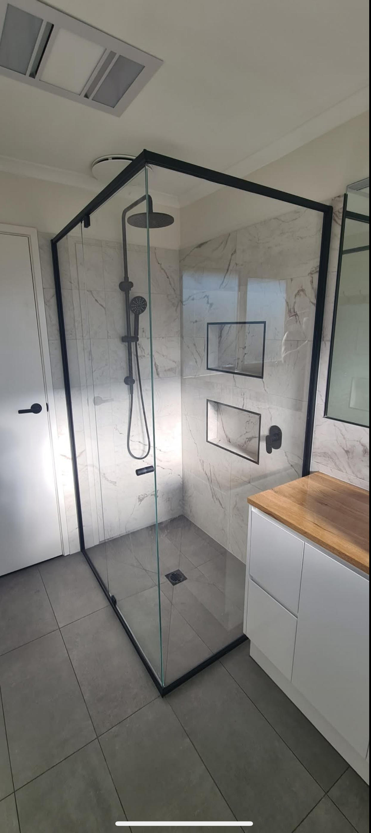 A Modern Bathroom with A Glass Shower — Flintoff Constructions in Armstrong Creek, VIC