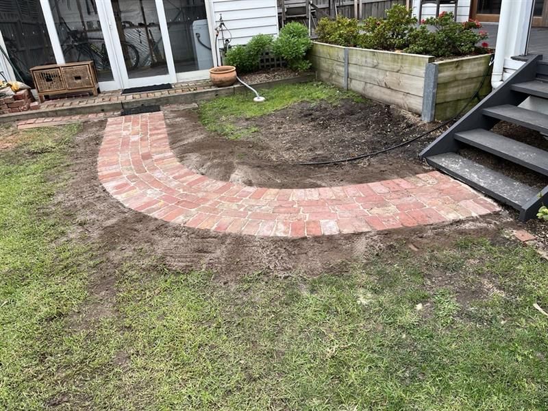 A garden with a. big green plant next to gravel and a shovel— Flintoff Constructions in Charlemont, VIC