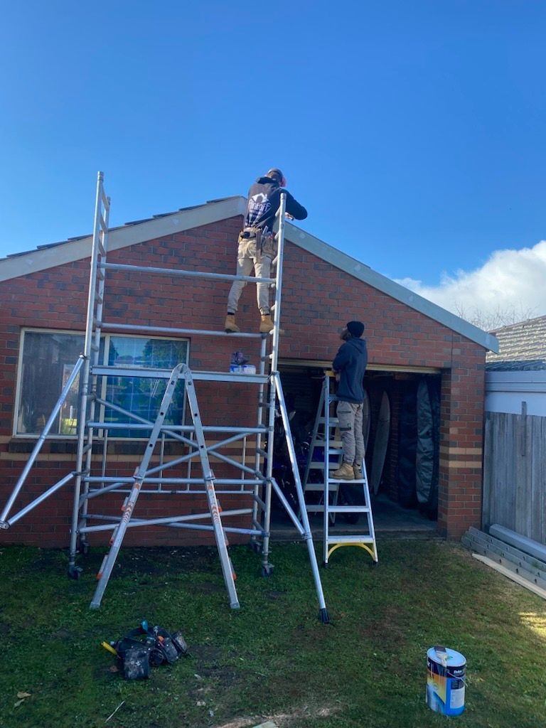 A Brick Building with A Fence and Stepping Stones in Front of It — Flintoff Constructions in Charlemont, VIC