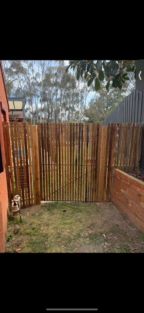 Wooden Fence Along a Sidewalk Next to A Stone Wall — Flintoff Constructions in Charlemont, VIC
