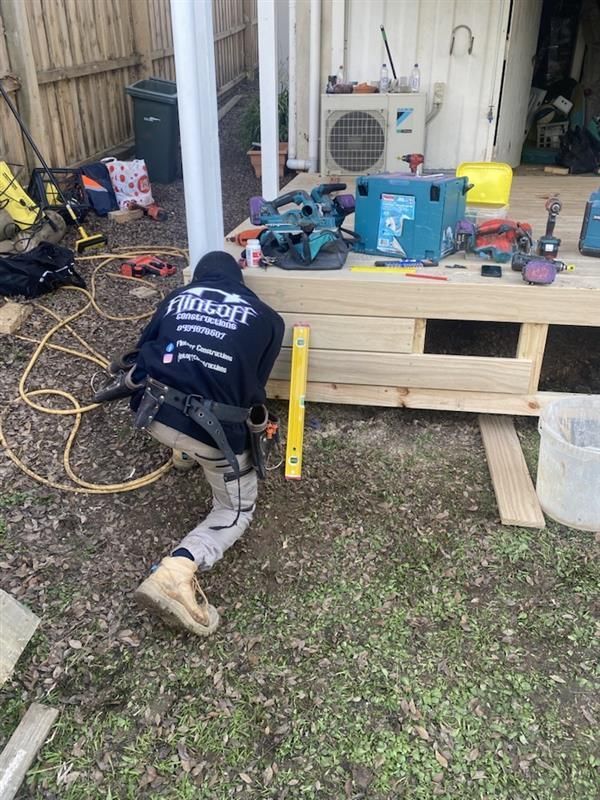 A man standing on a roof and a red ladder — Flintoff Constructions in Charlemont, VIC