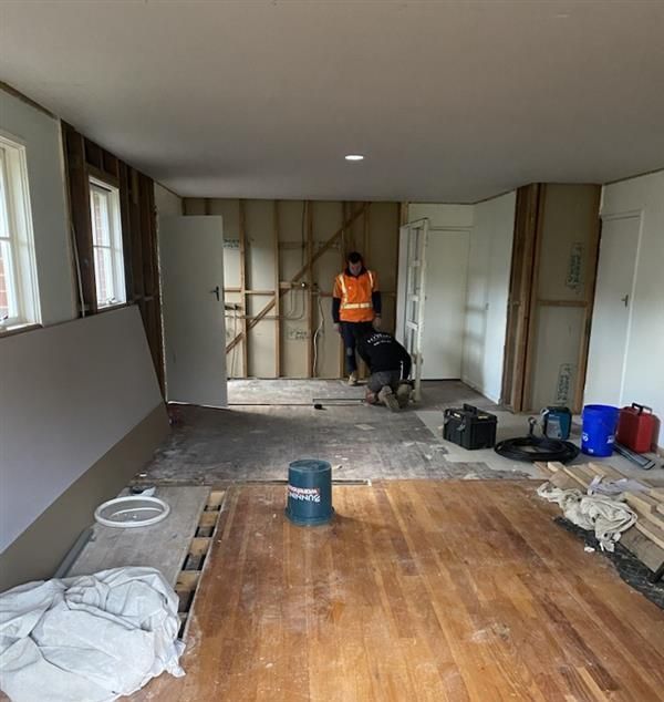 An Empty Room with A Ladder and A Window Under Construction — Flintoff Constructions in Charlemont, VIC