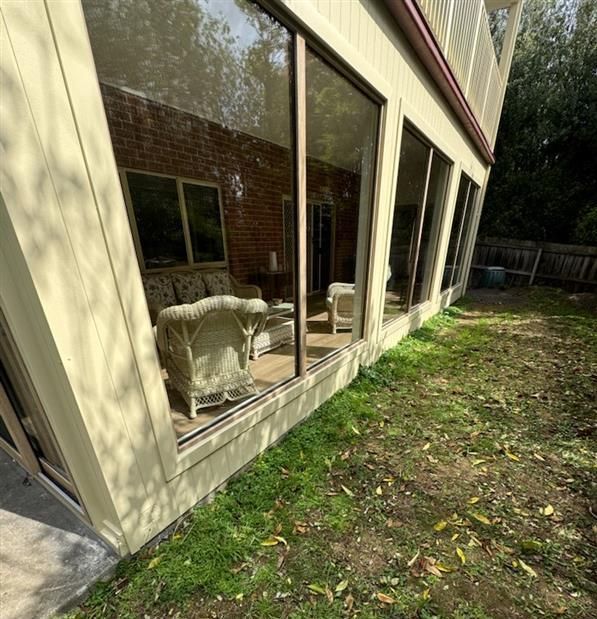 A Person Is Fixing a Window with A Screwdriver — Flintoff Constructions in Charlemont, VIC