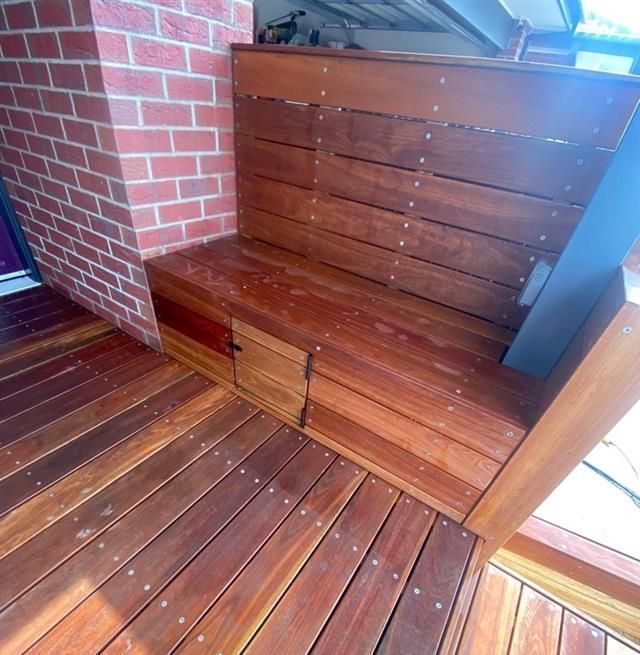 A wooden deck with two wooden bench seats — Flintoff Constructions in Charlemont, VIC