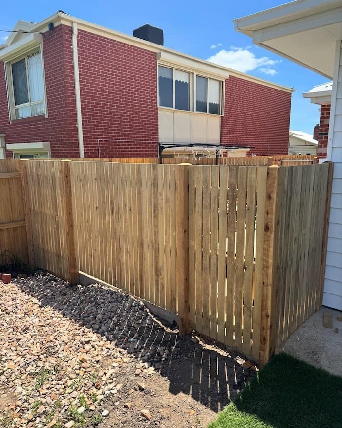 Wooden Fence Is in Front of A Brick Building — Flintoff Constructions in Charlemont, VIC