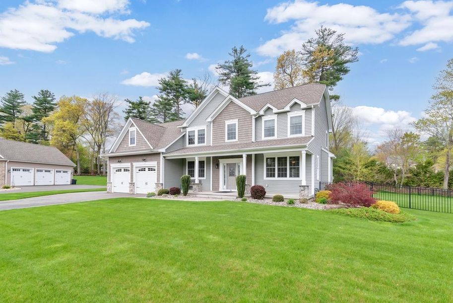 A large house with a large lawn in front of it.