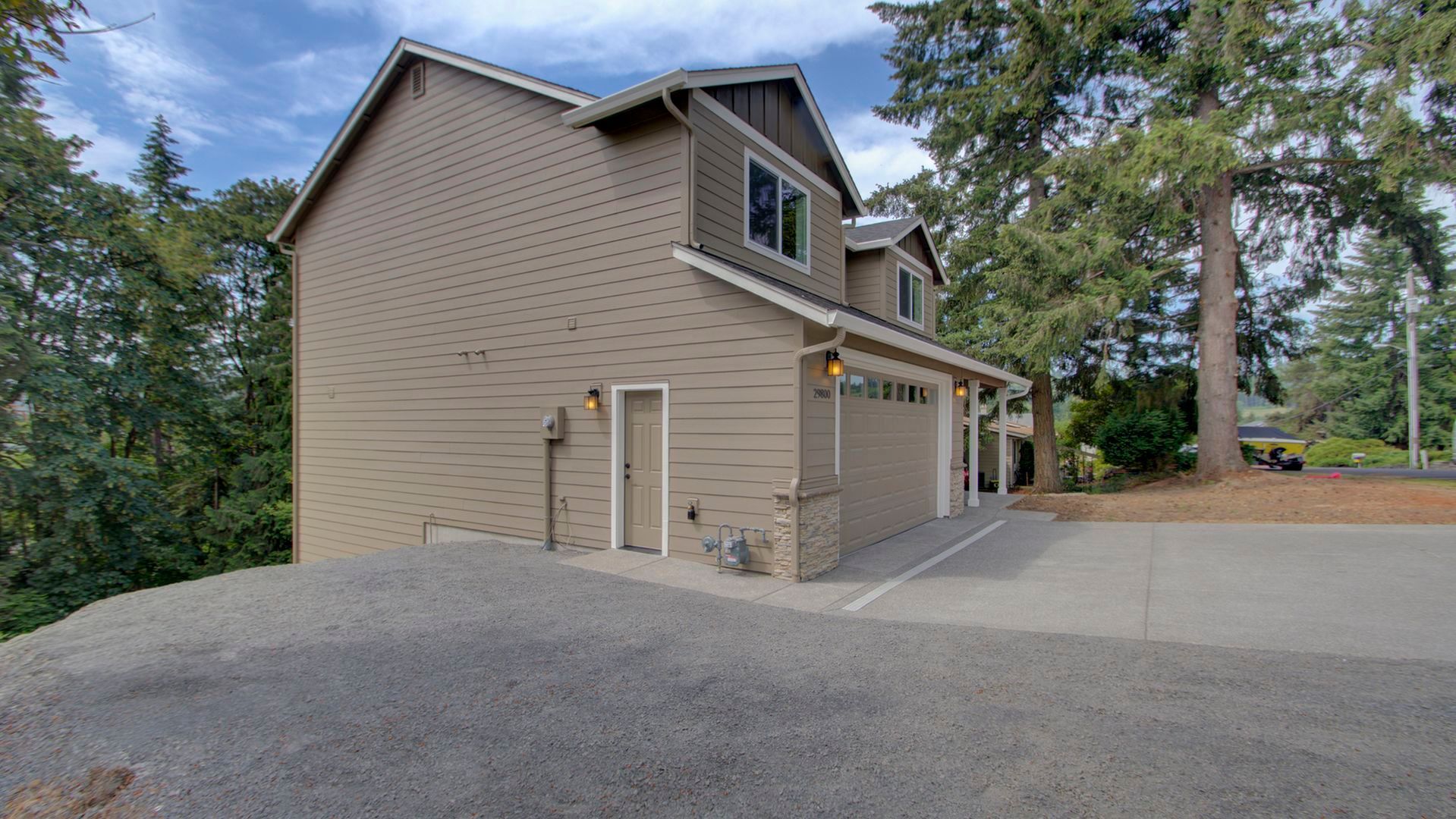 A house with a garage and a driveway in front of it