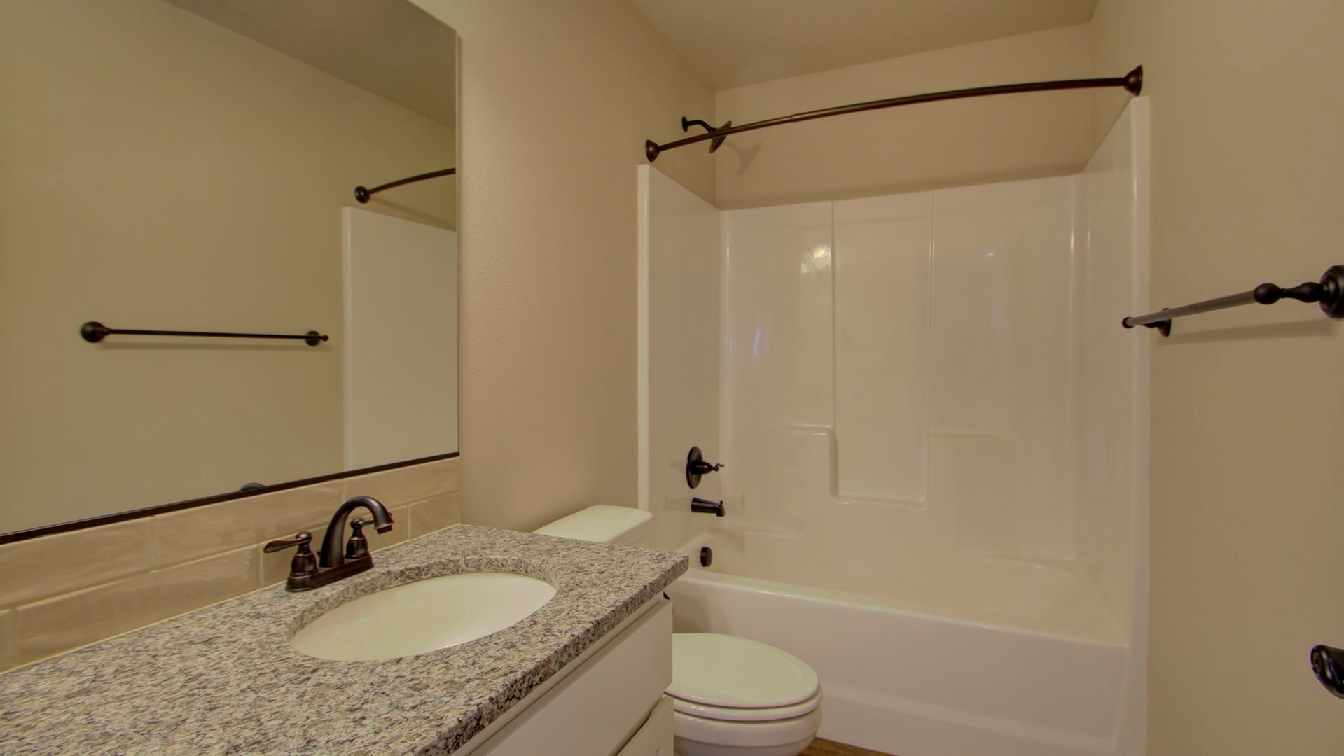 A bathroom with a sink , toilet , bathtub and mirror.