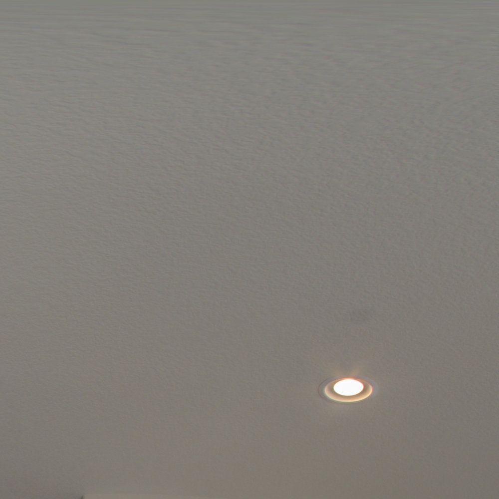 A light is shining through a hole in the ceiling.