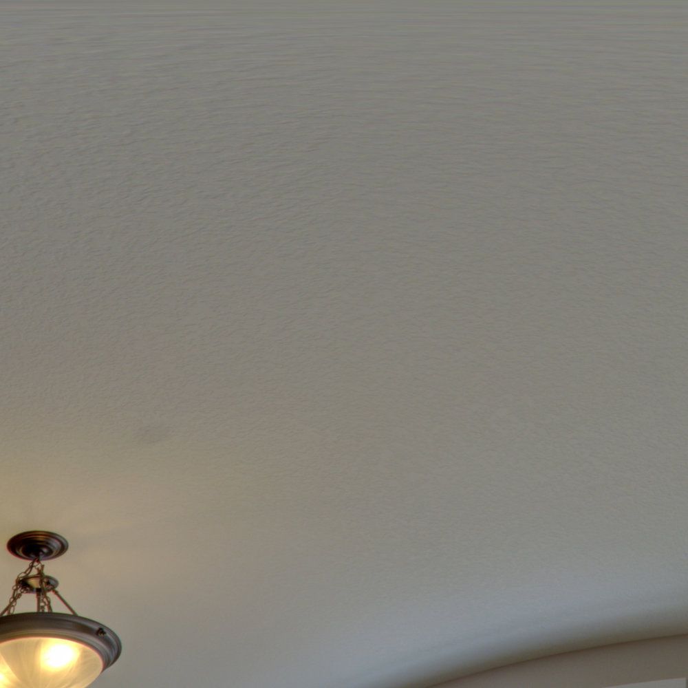 A light fixture is hanging from the ceiling of a room.