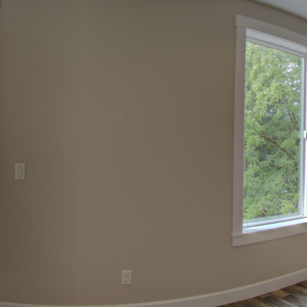 There is a large window in the corner of the room.