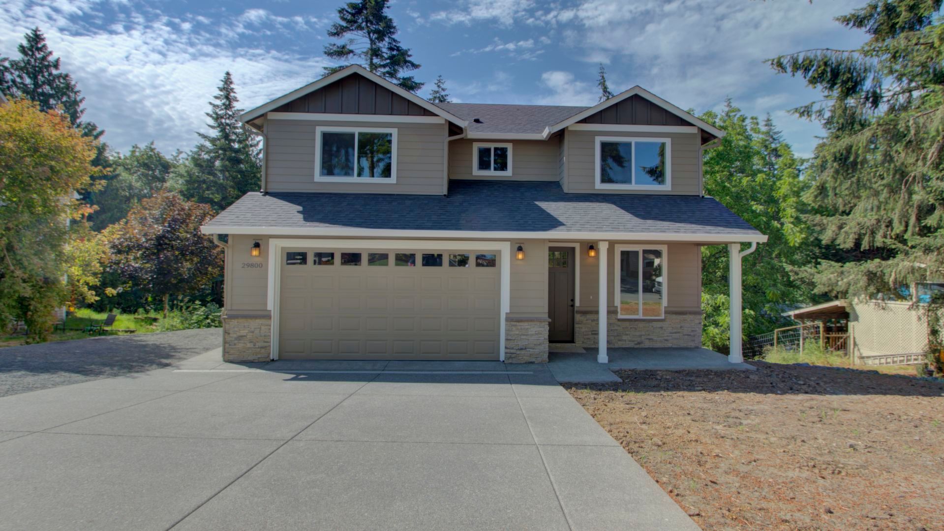 A large house with a concrete driveway in front of it