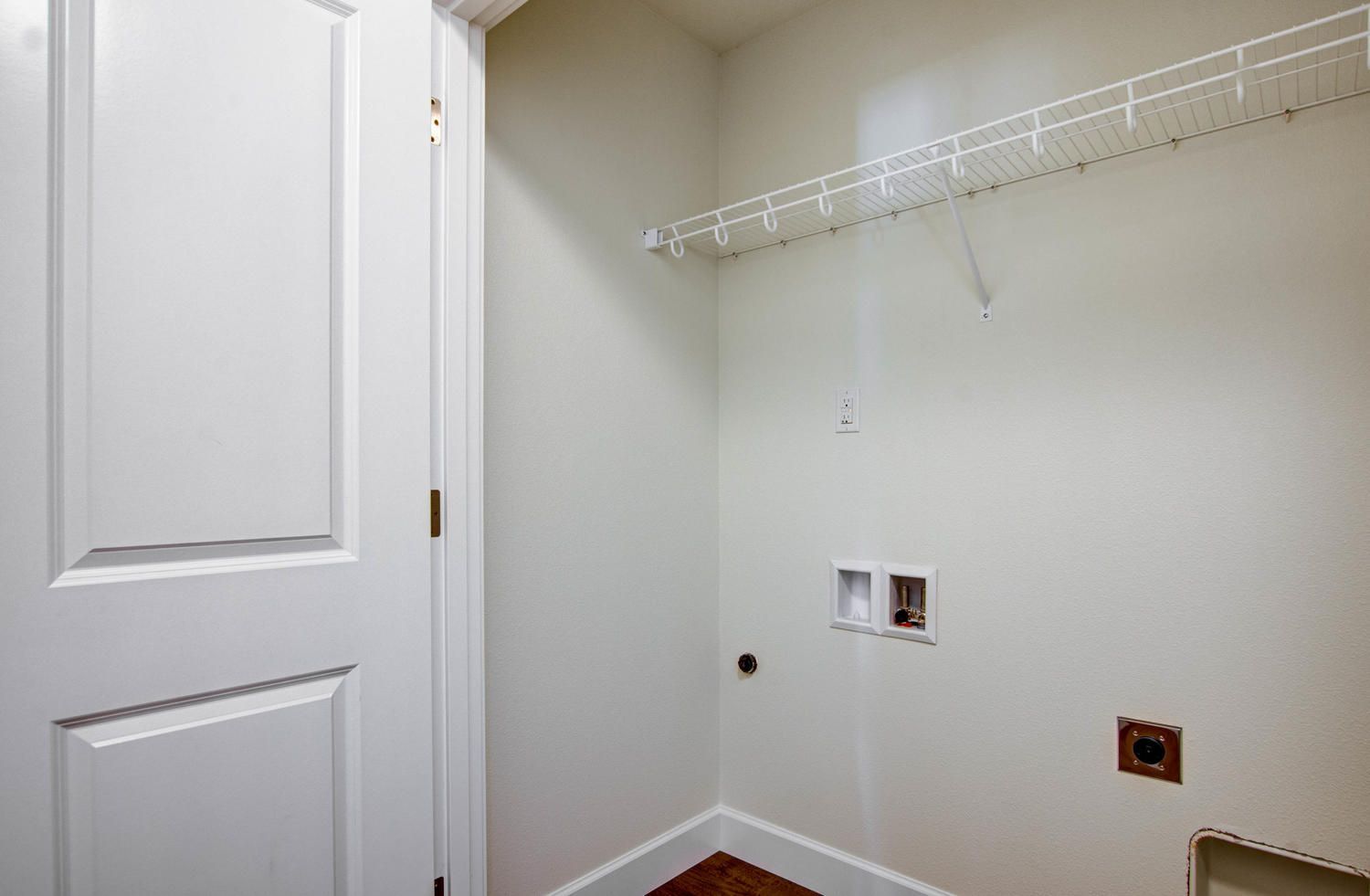 A laundry room with a washer and dryer in a house.