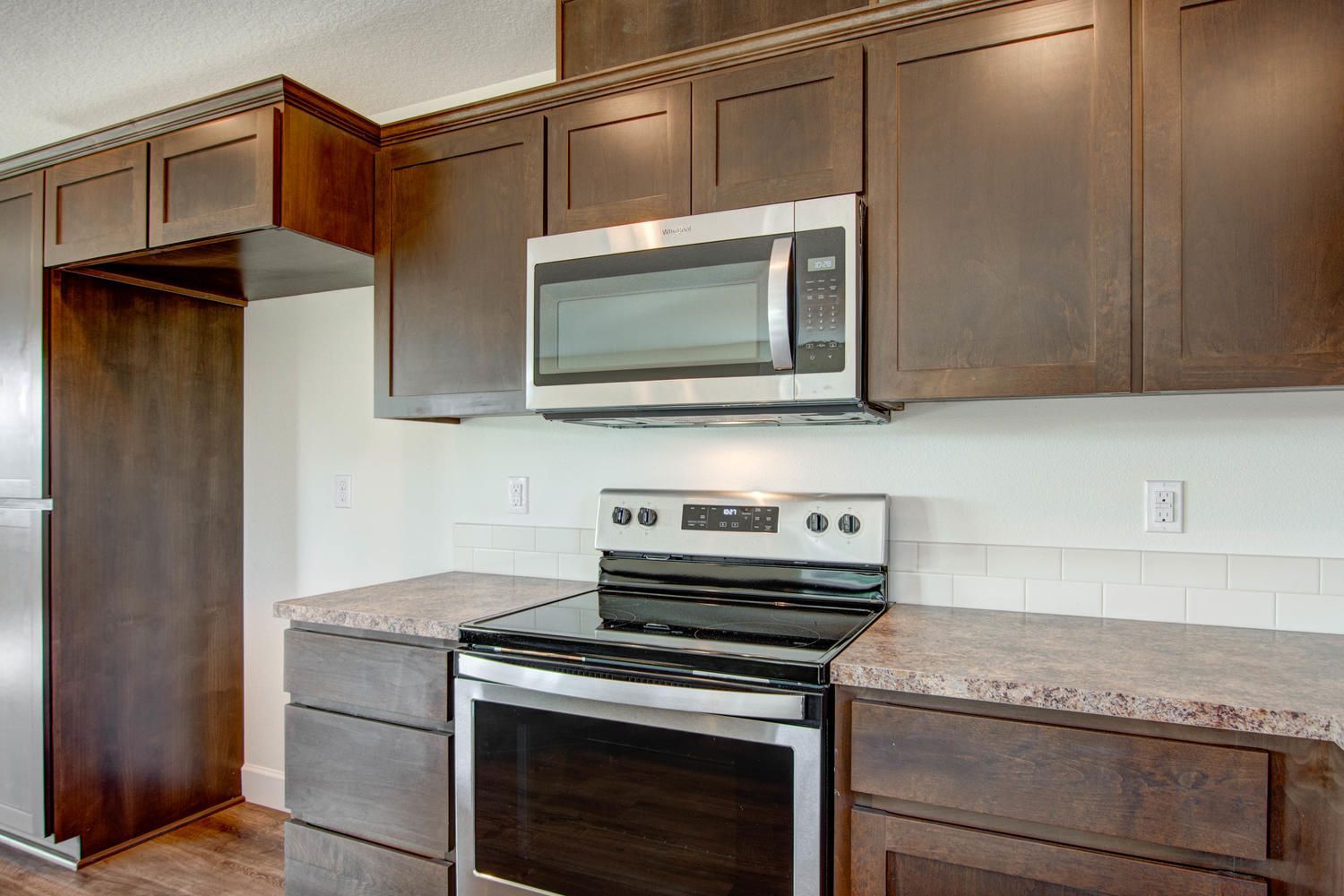 A kitchen with stainless steel appliances and wooden cabinets