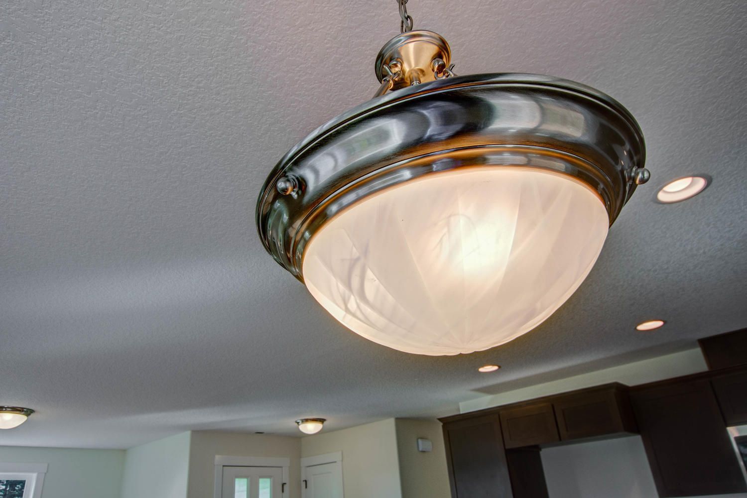 A ceiling light is hanging from the ceiling in a kitchen