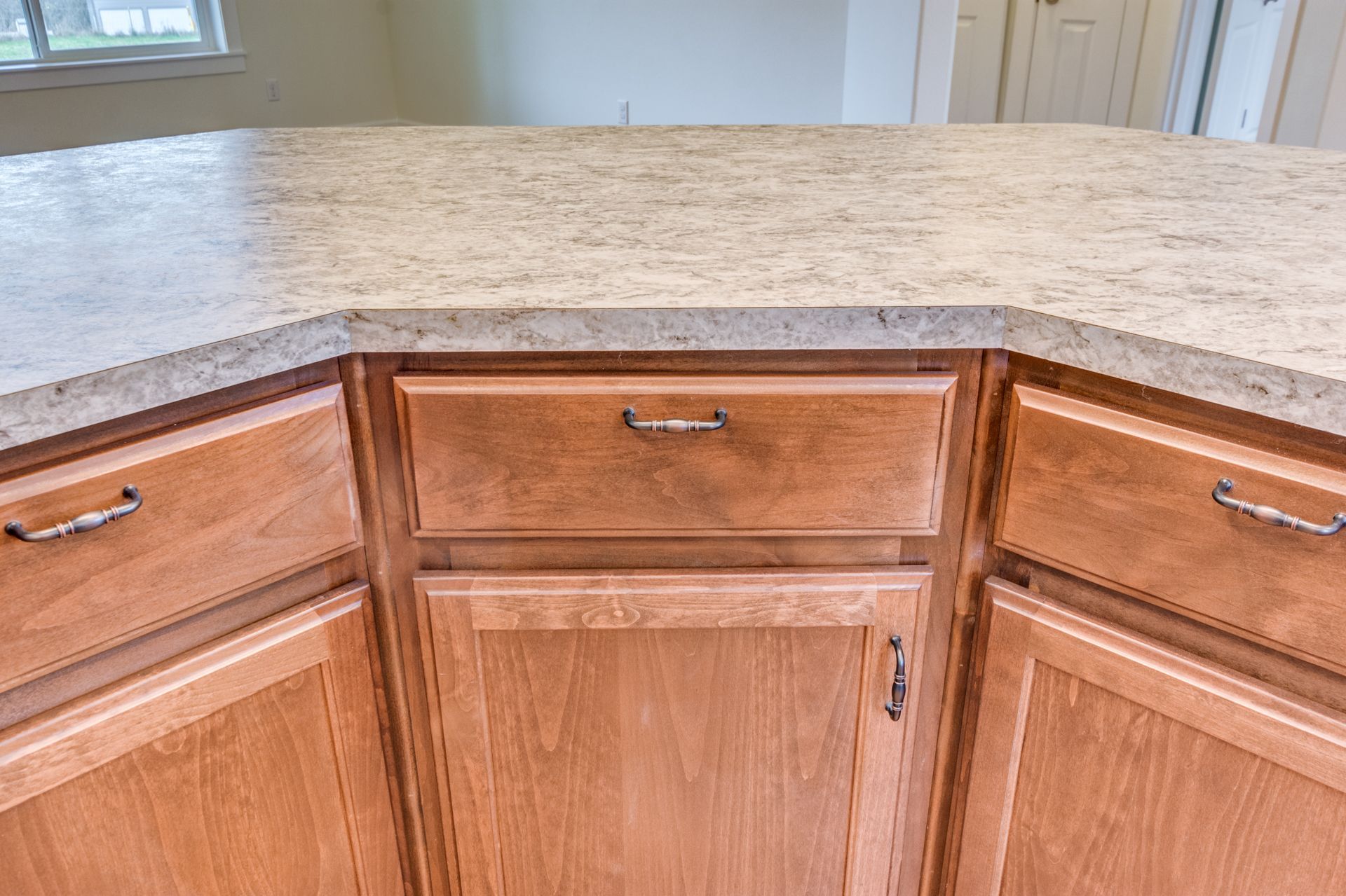 A kitchen with wooden cabinets and a granite counter top.