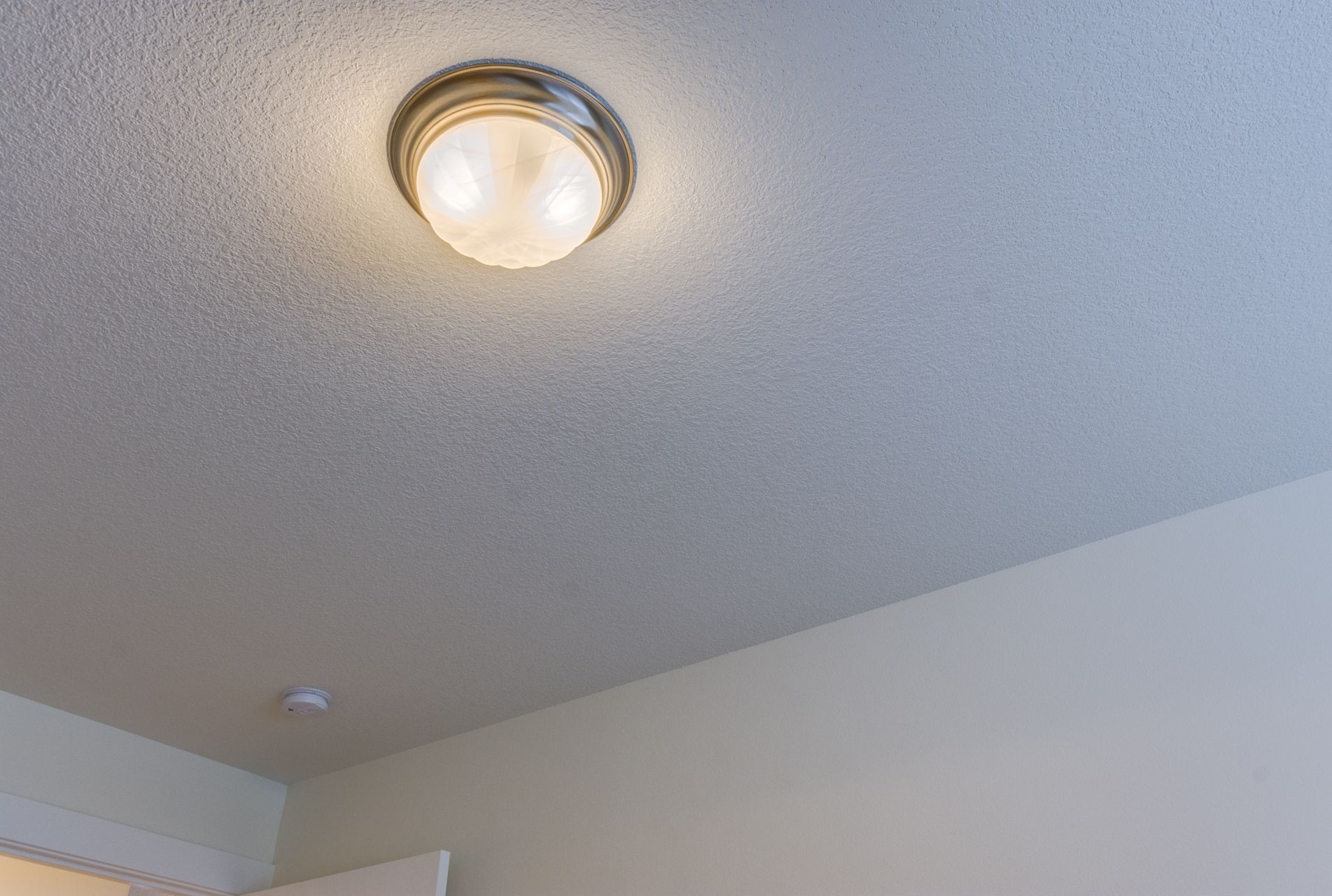 A ceiling light is hanging from the ceiling of a room.