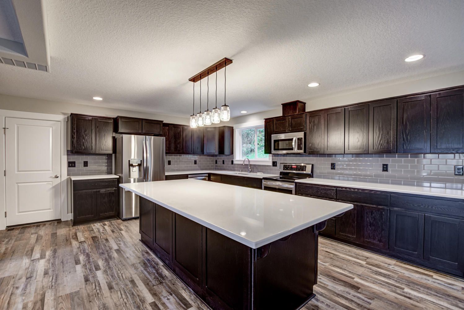 There is a large island in the middle of the kitchen.