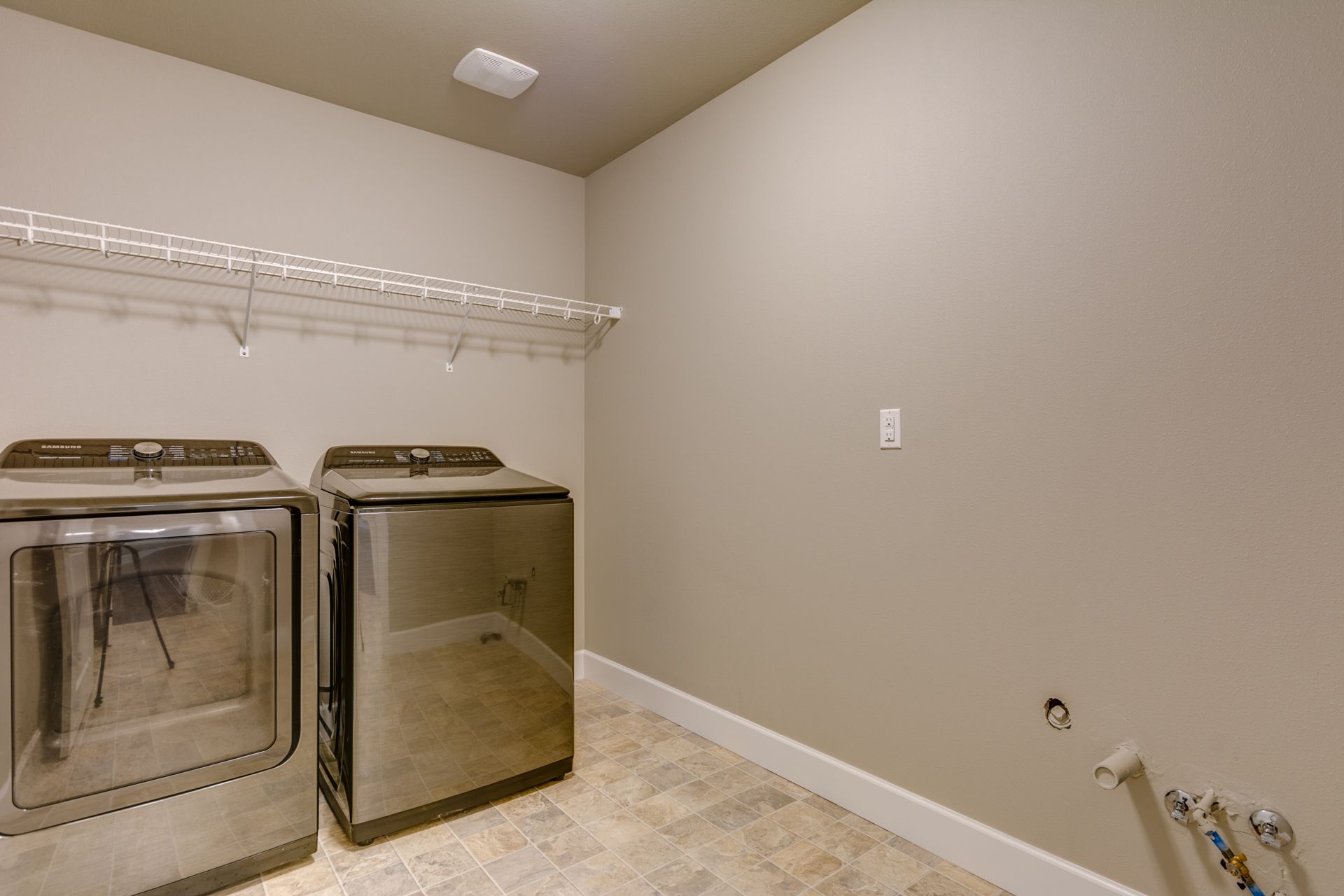 A laundry room with a washer and dryer in it.