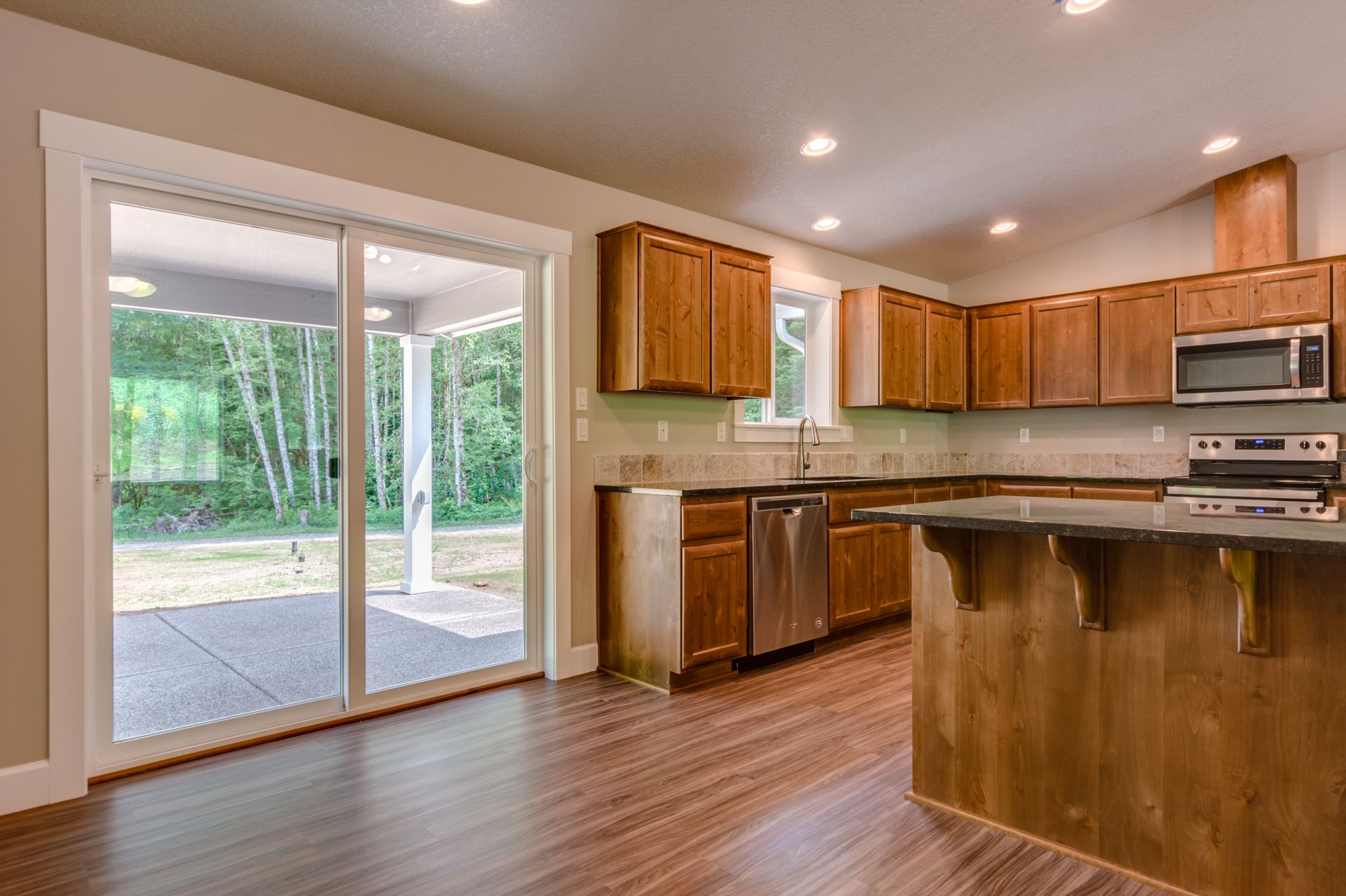 A kitchen with sliding glass doors leading to a patio.