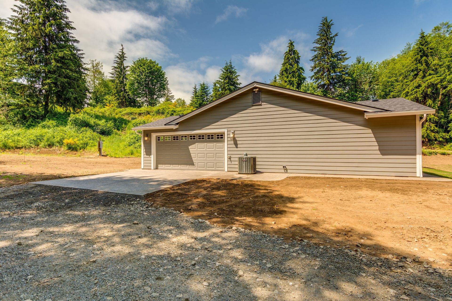 A house with a garage and a driveway in front of it