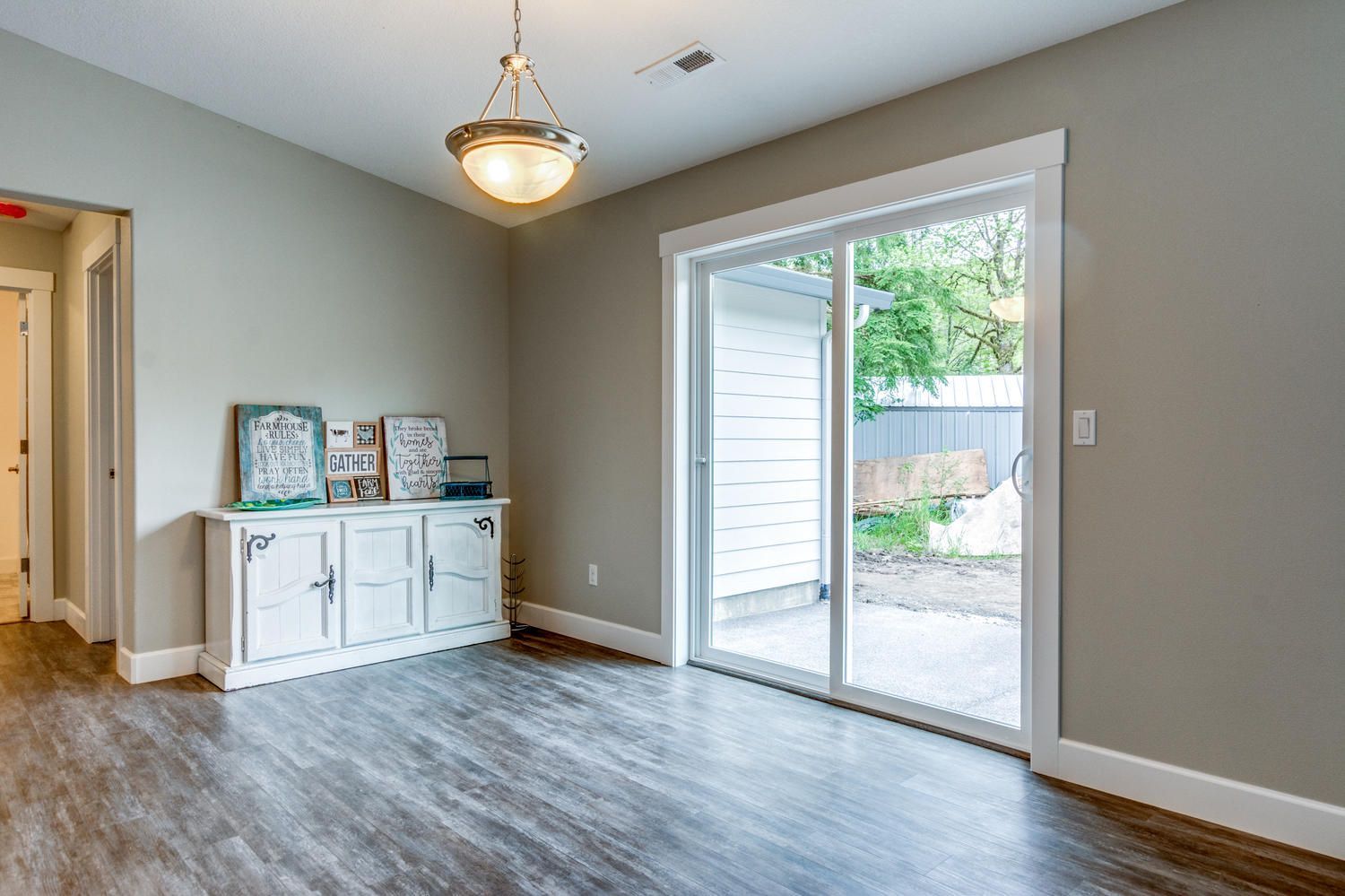 A living room with a sliding glass door leading to a patio.
