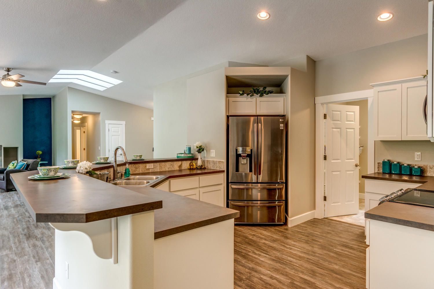A kitchen with stainless steel appliances and a stainless steel refrigerator.