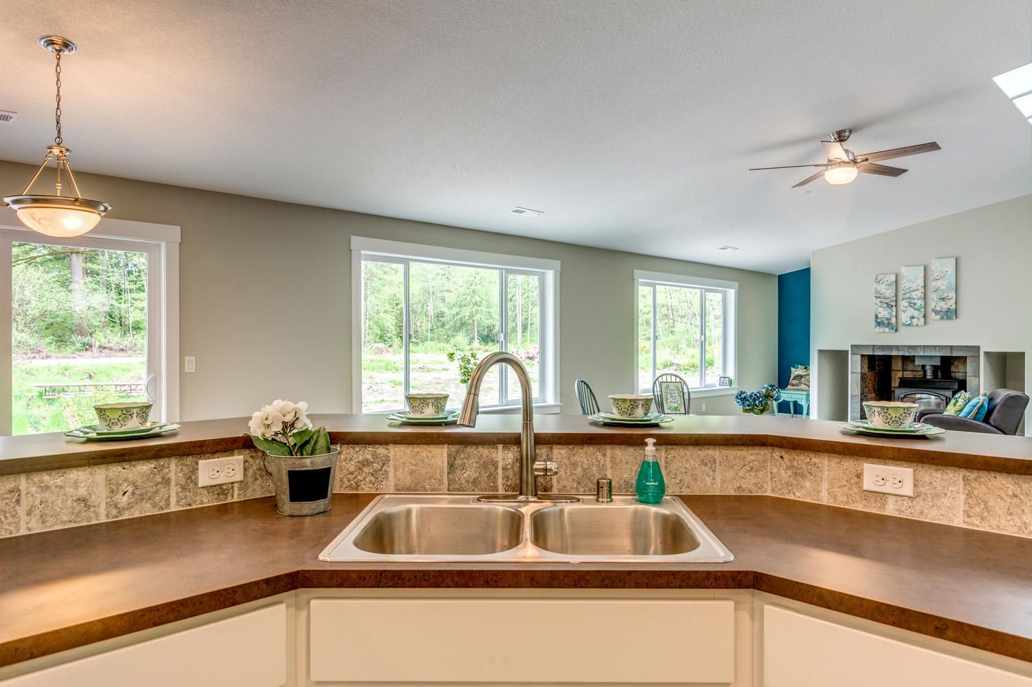 A kitchen with a double sink and a ceiling fan.