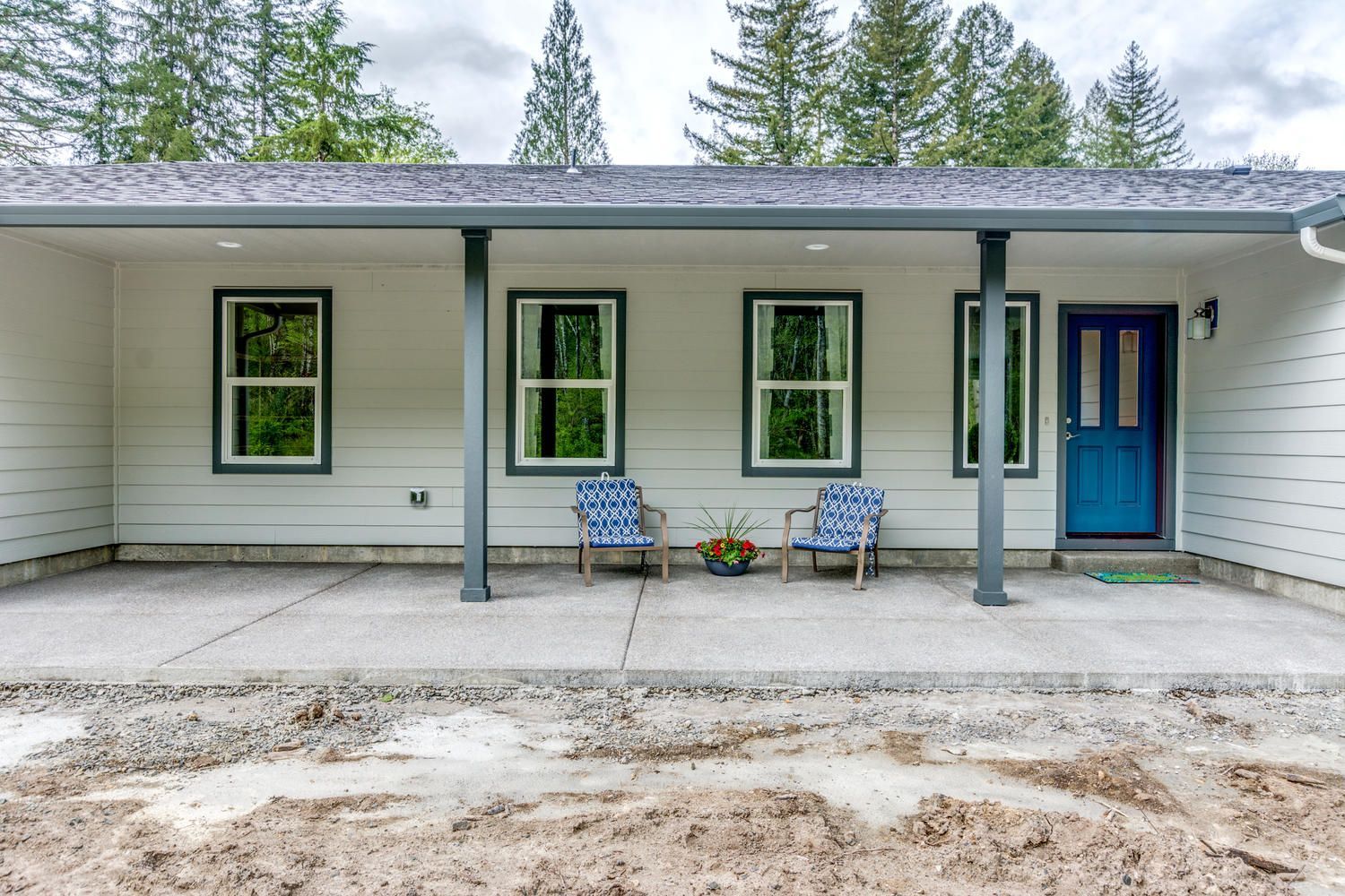A white house with a blue door and a porch