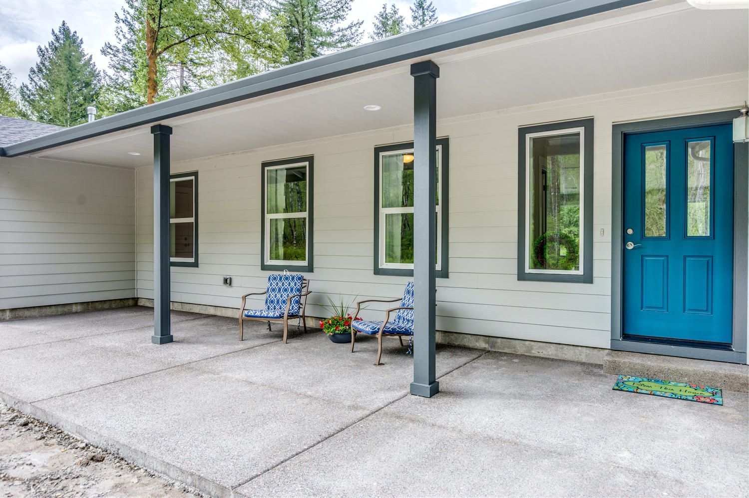 A white house with a blue door and a porch