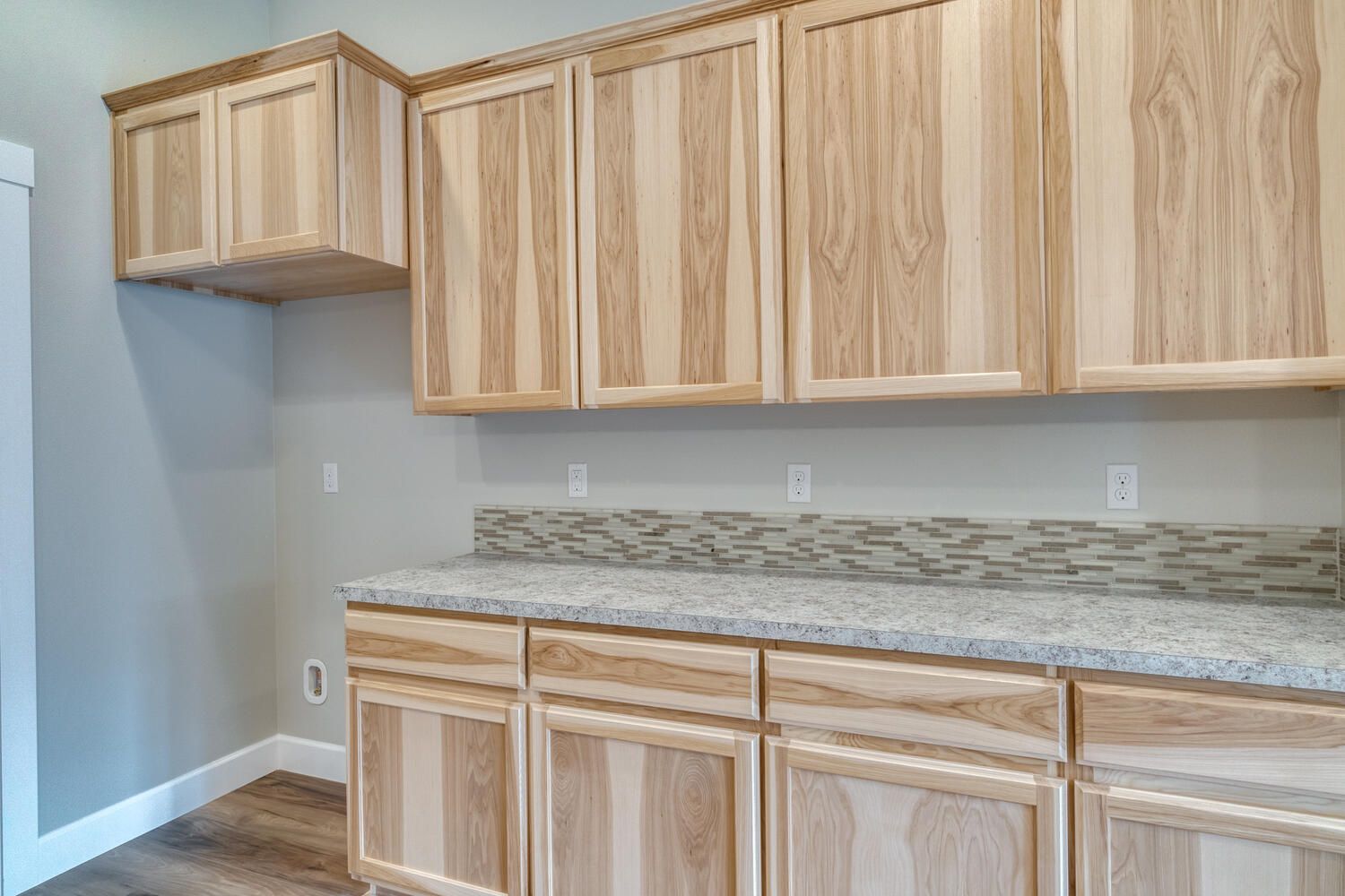 A kitchen with wooden cabinets and granite counter tops.