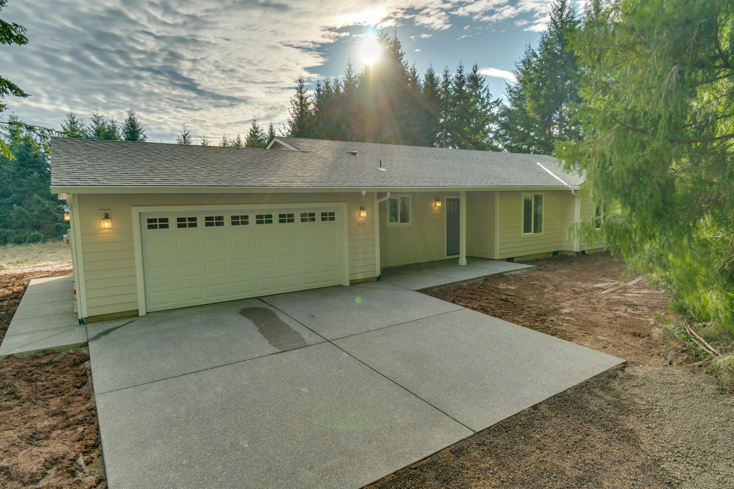 A house with a garage and a driveway in front of it