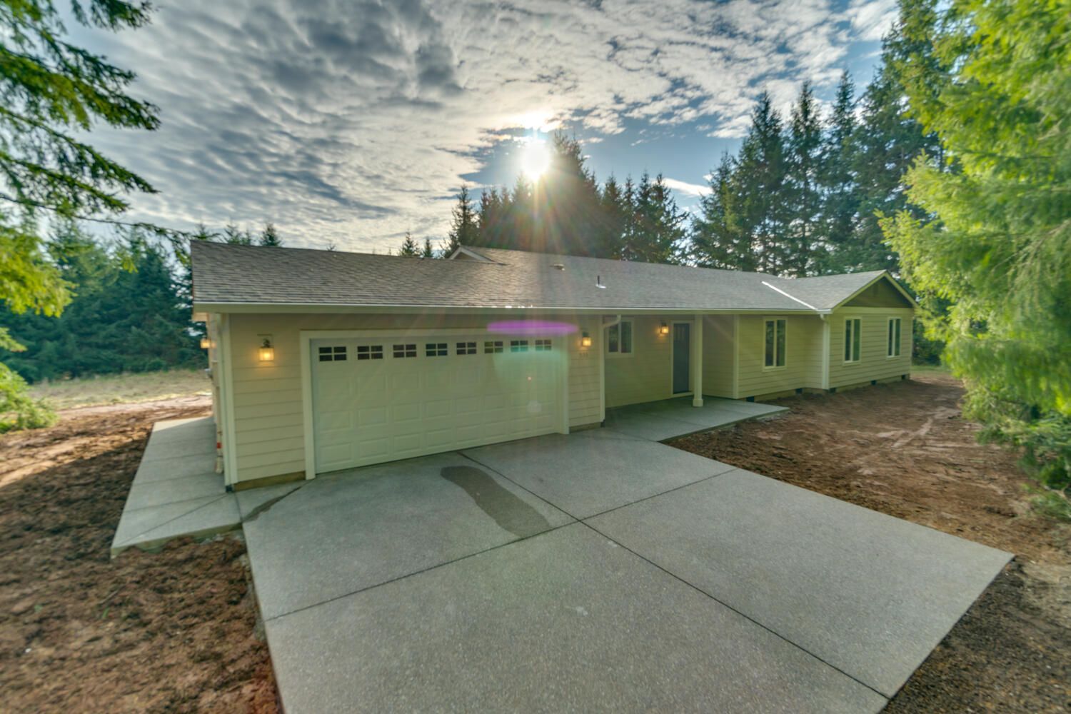 A house with a garage and a driveway in front of it