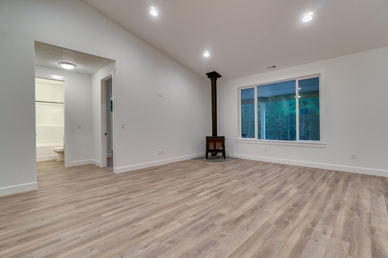 There is a wood stove in the middle of the living room.