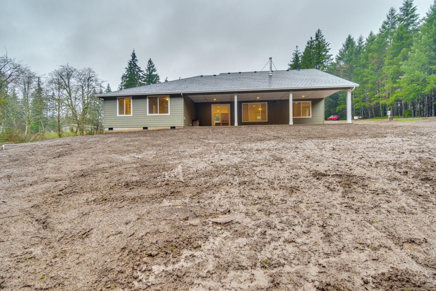 A house is sitting in the middle of a dirt field