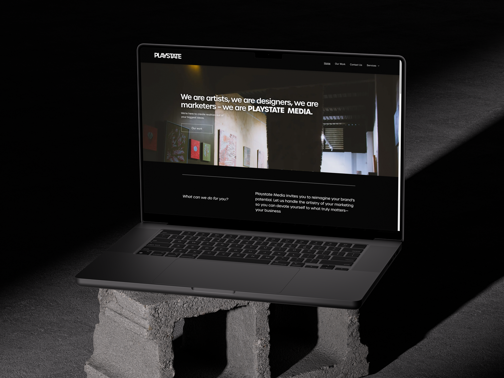 A laptop is sitting on top of a concrete block