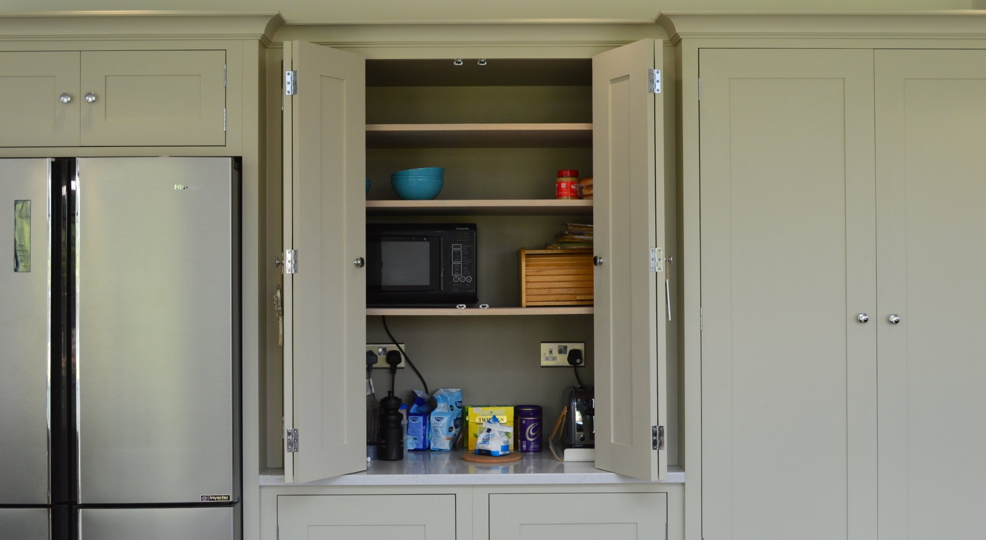 kitchen appliances neatly stored in a cupboard