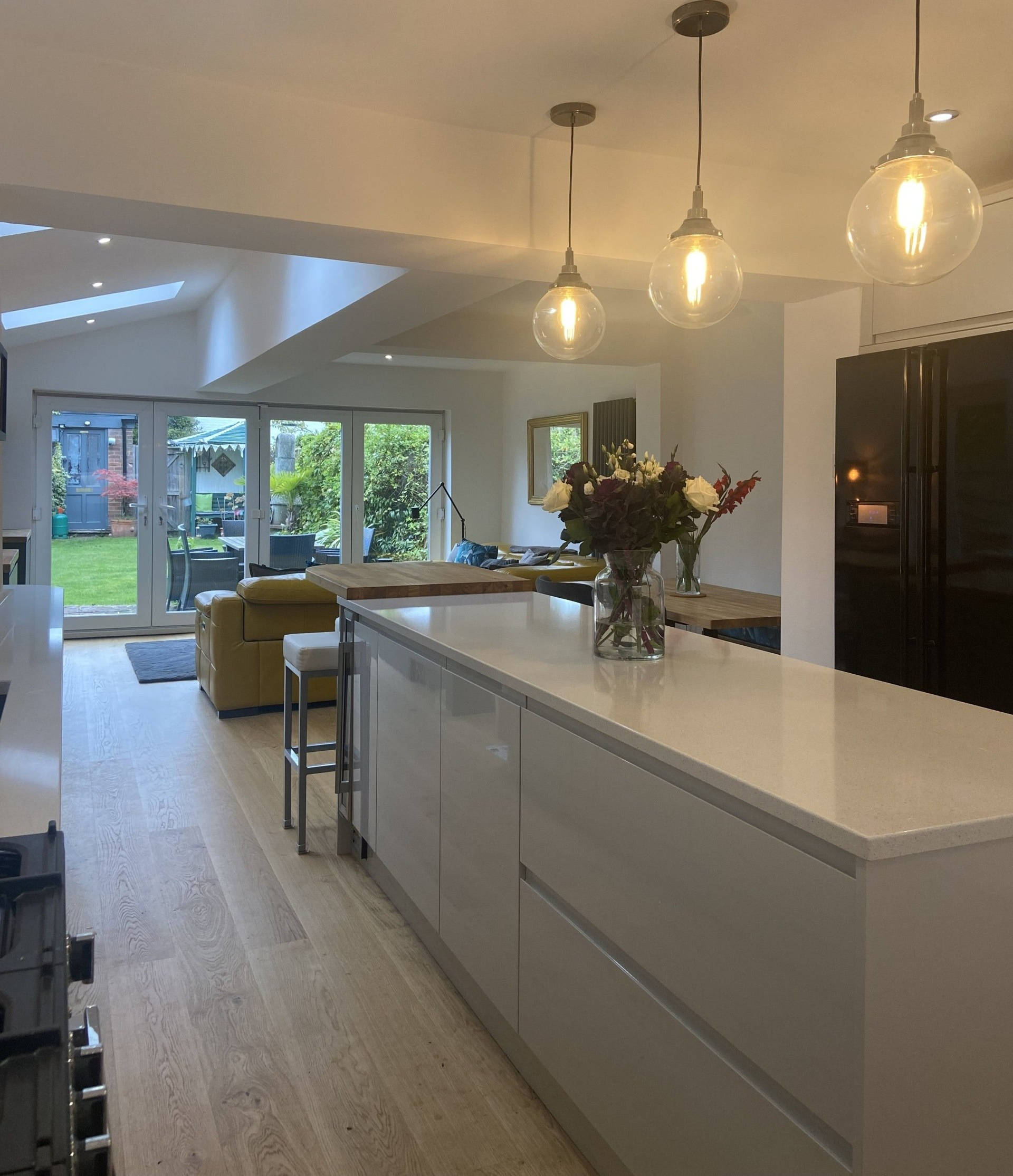 modern white kitchen with hanging globe pendant lights