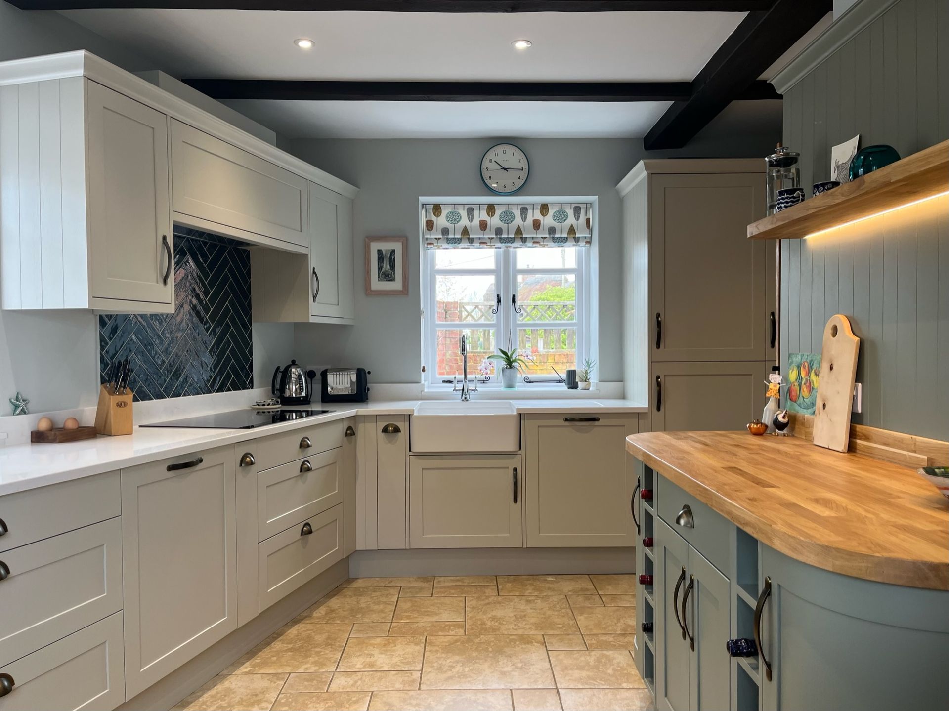 Traditional shaker kitchen with tiled floor, belfast sink and ceiling beams