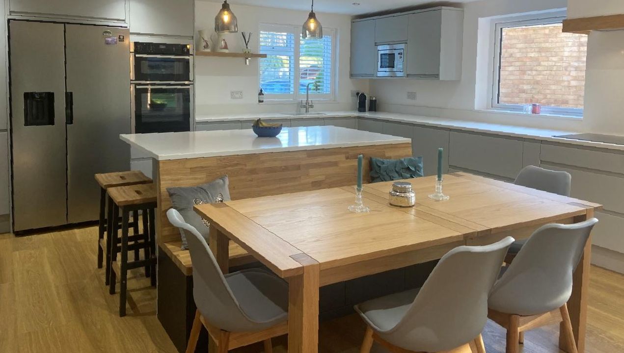 Contemporary family kitchen design with bespoke island bench seating and dining table