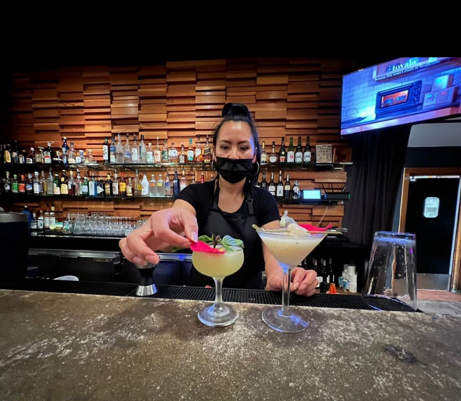 Our bartender is serving martinis. 