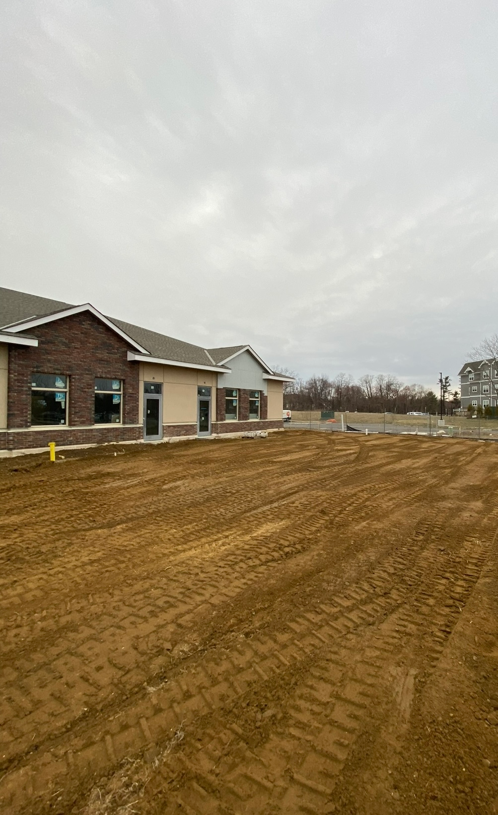 Overcast sky above an active construction site during excavation and infrastructure work.