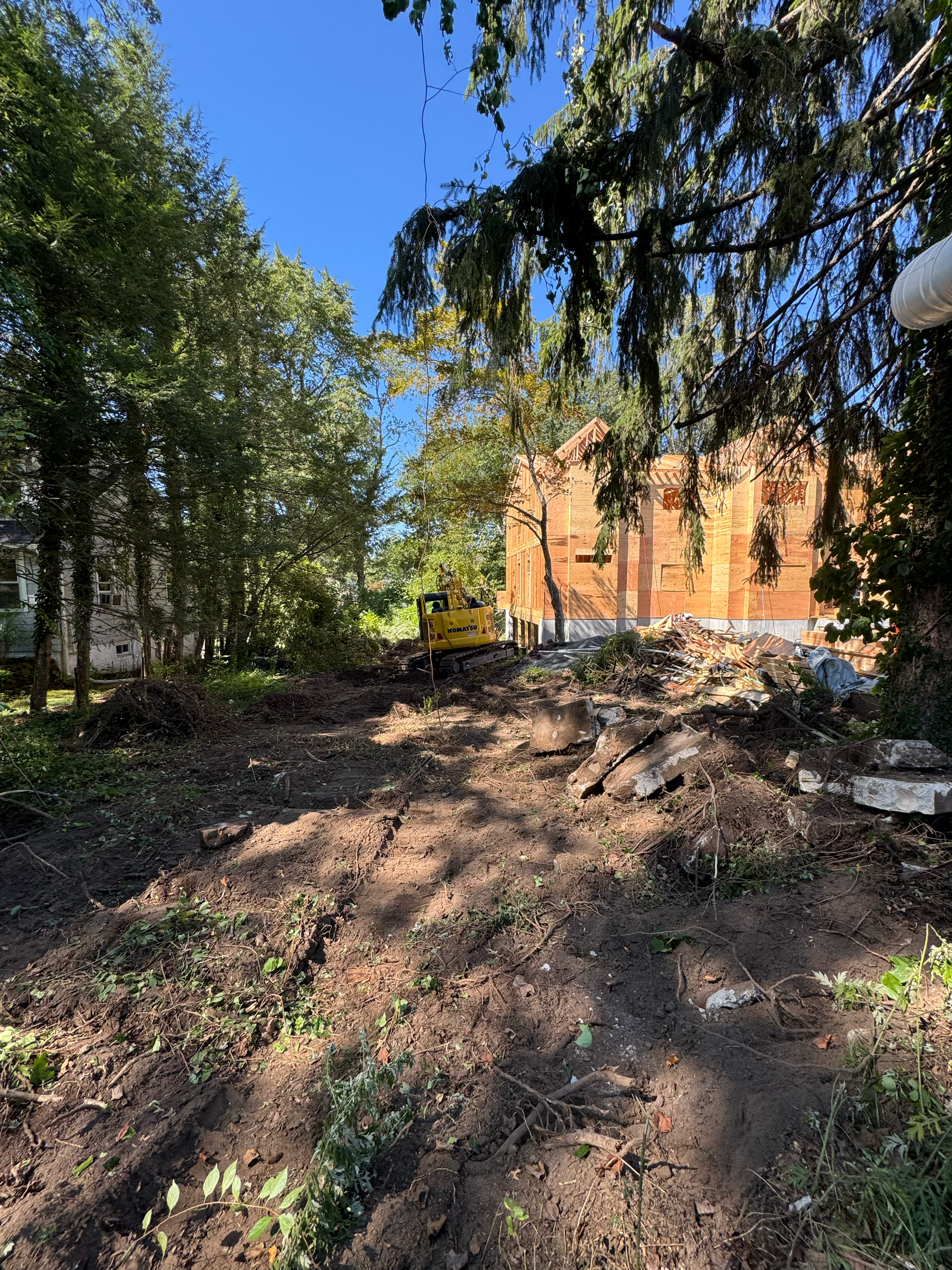 Cleared site with utility work and grading completed, preparing land for future construction or landscaping.