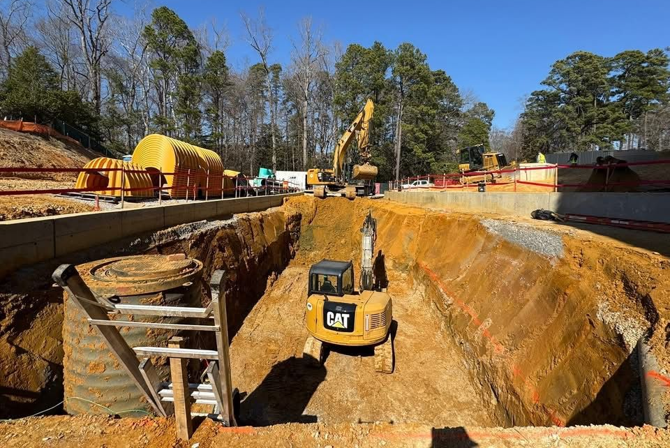 Construction site with excavators preparing land for utility installation and site development.