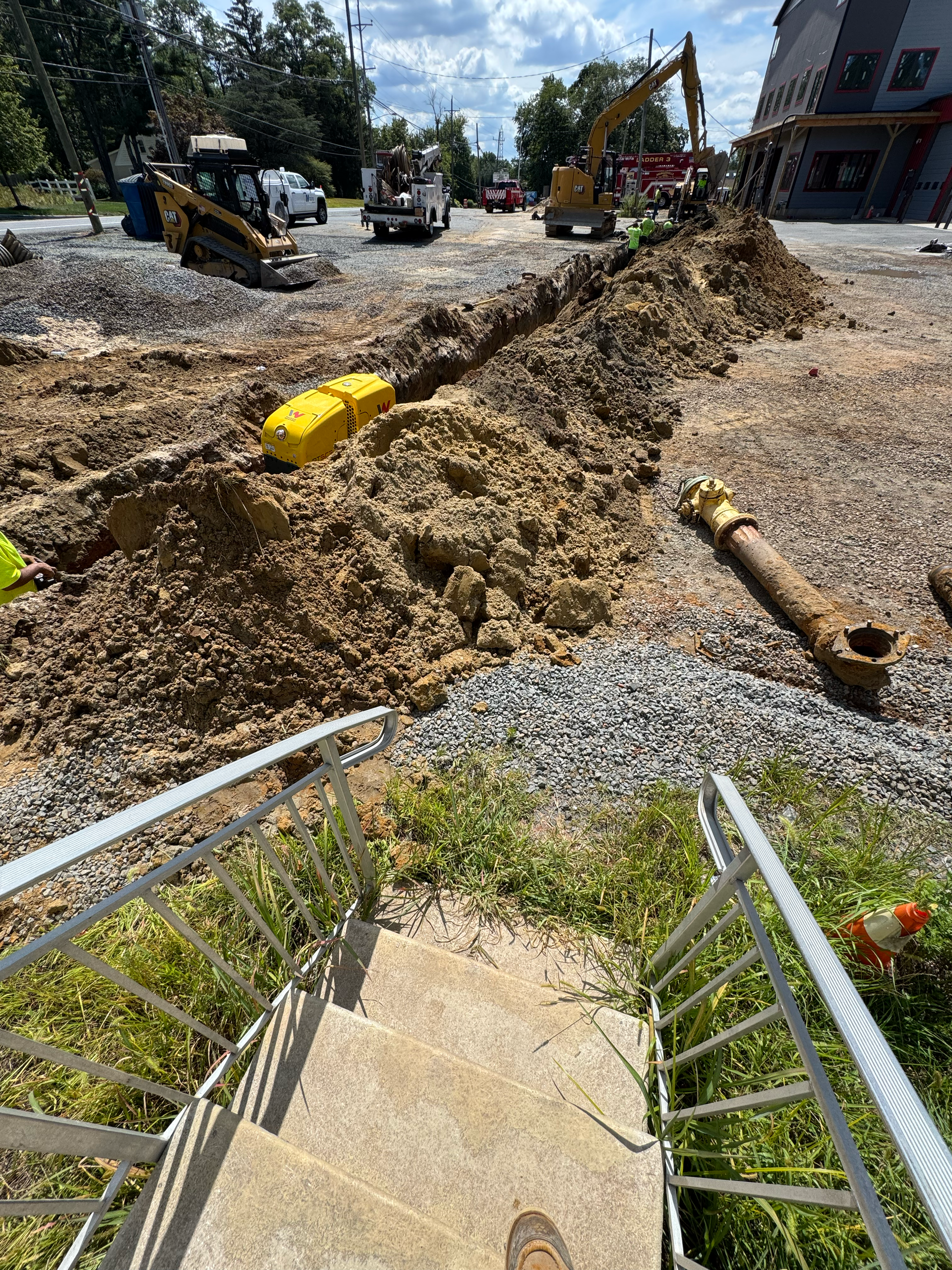 Utility trench excavation underway with heavy equipment preparing for underground infrastructure installation.