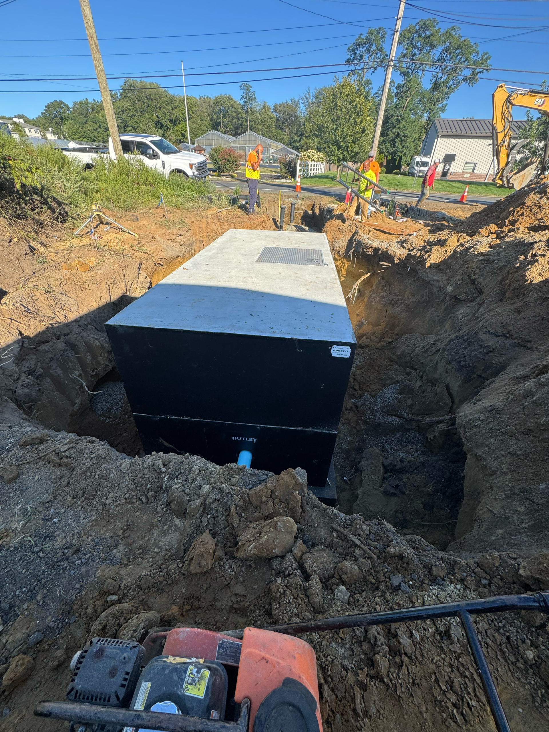 Construction team installing utilities in an excavated trench as part of an underground infrastructure project.