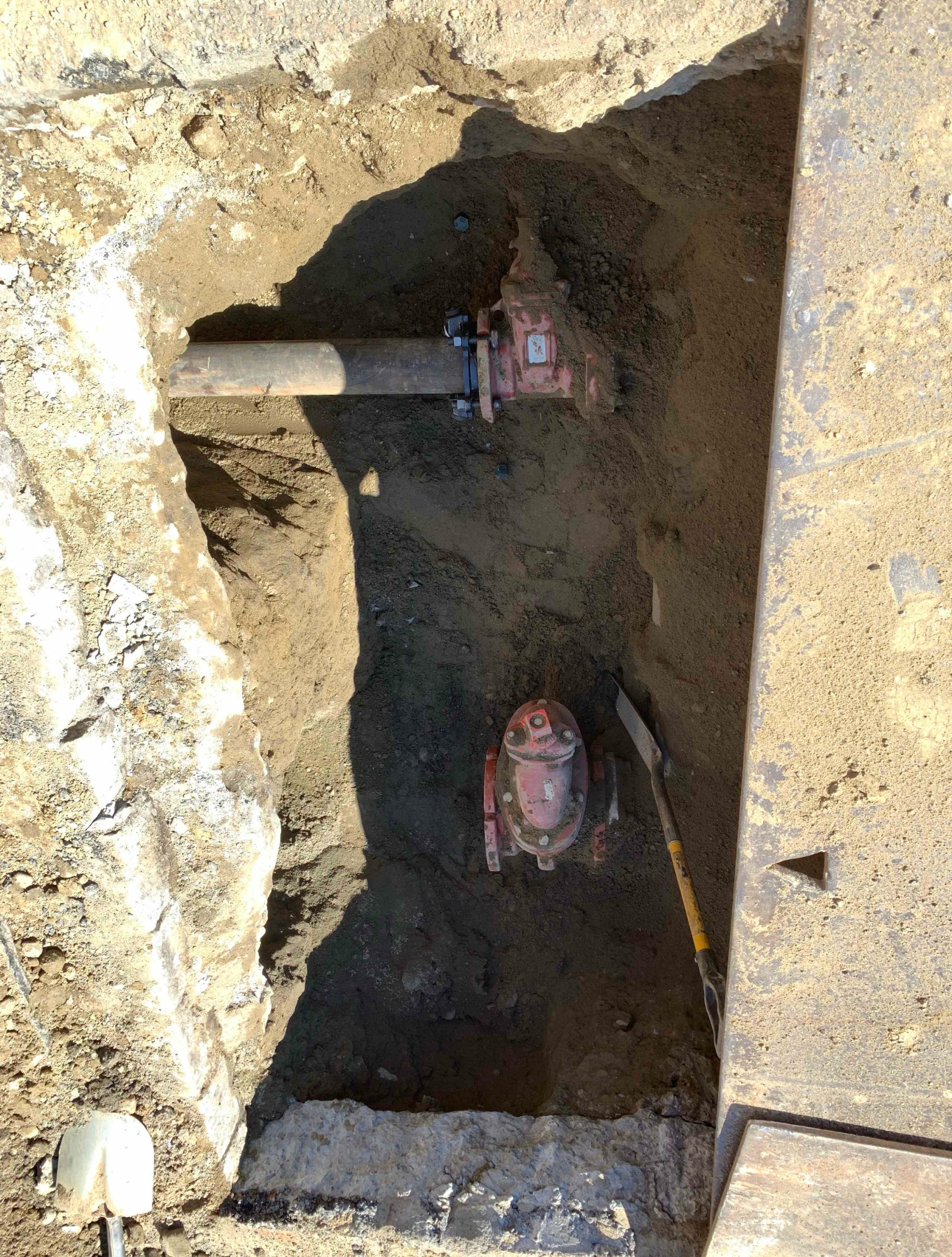 Underground valve installation for water or sewer infrastructure inside a prepared excavation pit.