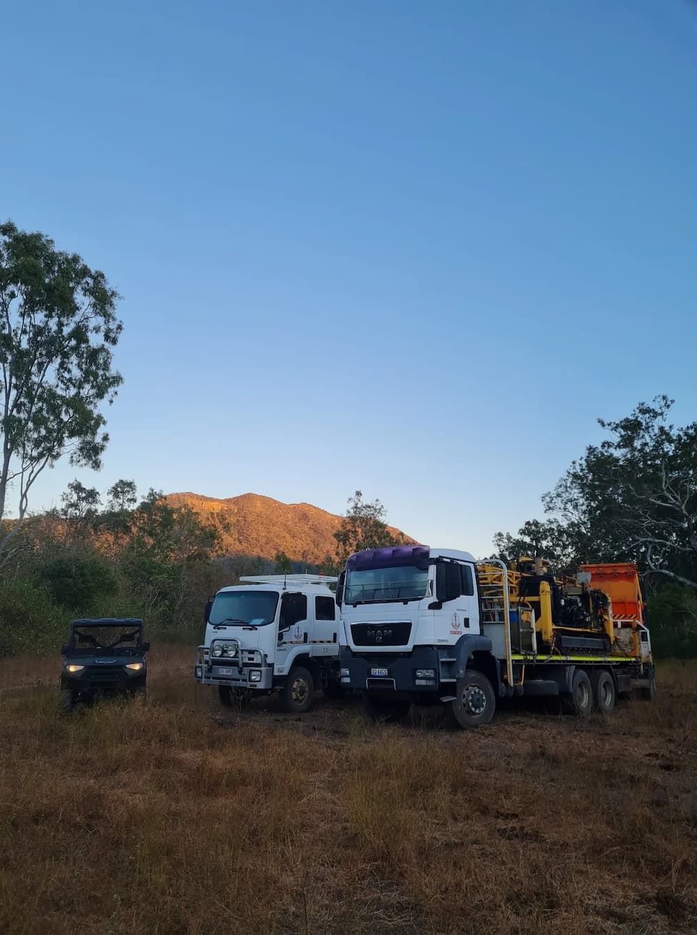 Heavy Duty Rental Trucks Stationed in a Field — Grid Drilling in Agnes Water, QLD