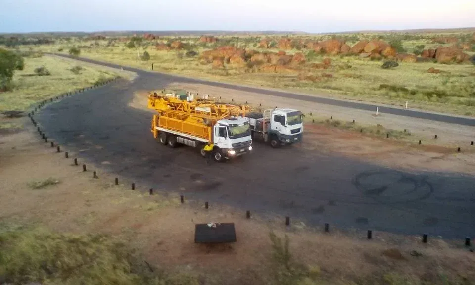 Trucks Traveling a Remote and Isolated Road — Grid Drilling in Munduberra, QLD