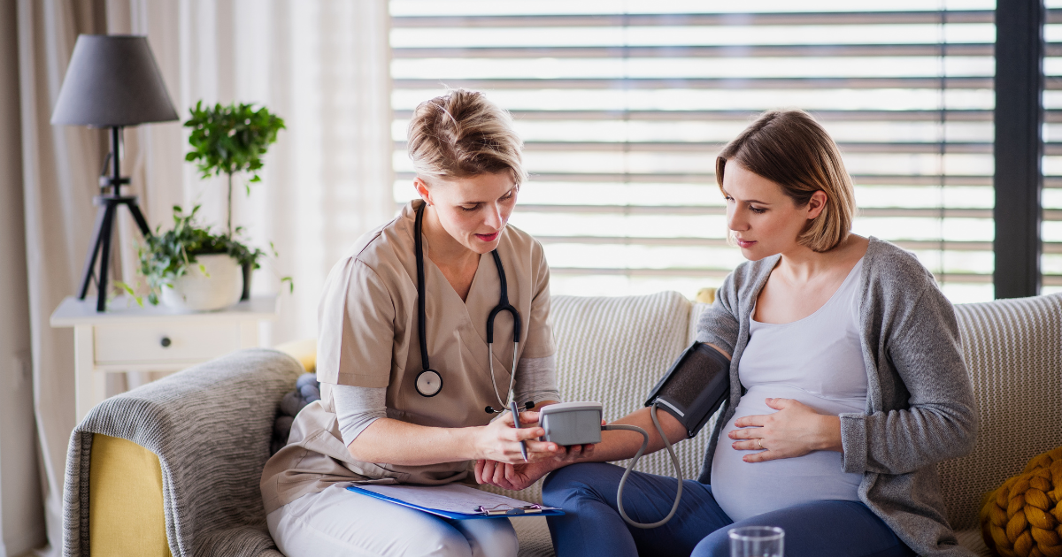 Concierge doctor providing in-home blood pressure check for pregnant woman in Las Vegas